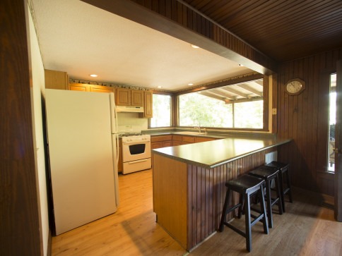 Kitchen and barstool area in cabin at Swaha Lodge & Marina.